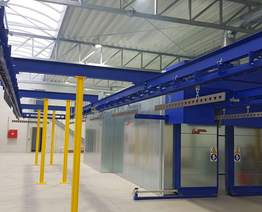 Curing oven with overhead conveyor